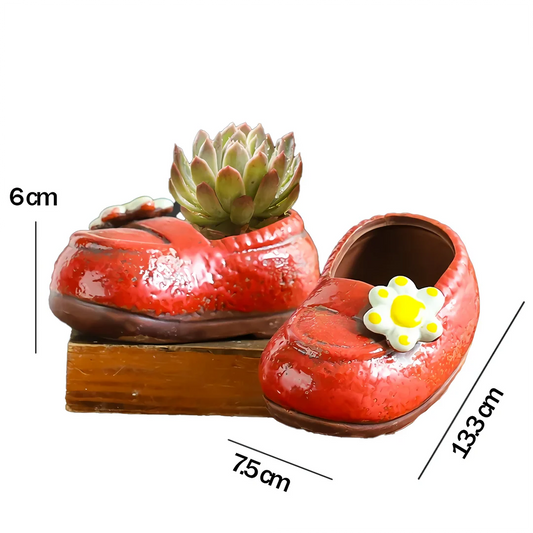 Charming ceramic boot-shaped vase with a glazed finish, perfect for displaying succulents and flowers in your home or garden