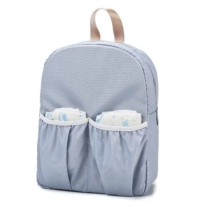 Versatile baby changing backpack with convertible crib bed, large storage capacity, and insulated feeding bottle compartment