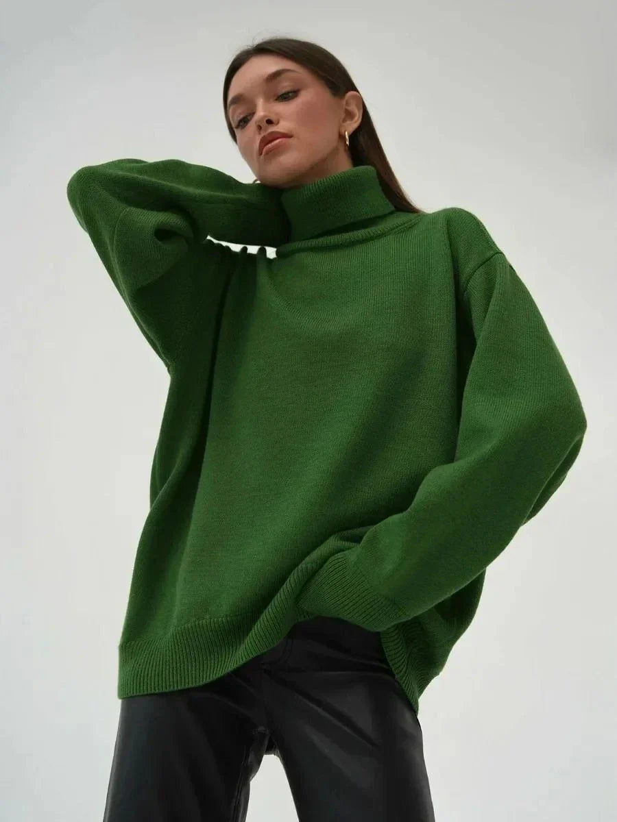 Cosy oversized knitted pullover in blue, featuring a classic turtleneck collar and drop-shoulder silhouette for maximum comfort and style.