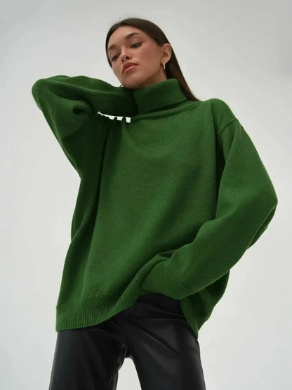 Cosy oversized knitted pullover in blue, featuring a classic turtleneck collar and drop-shoulder silhouette for maximum comfort and style.