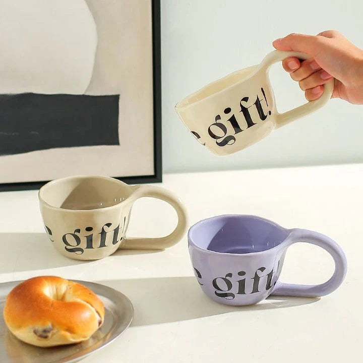 Handcrafted creative alphabet ceramic mug in beige, purple, and khaki colours for hot drinks like coffee and tea
