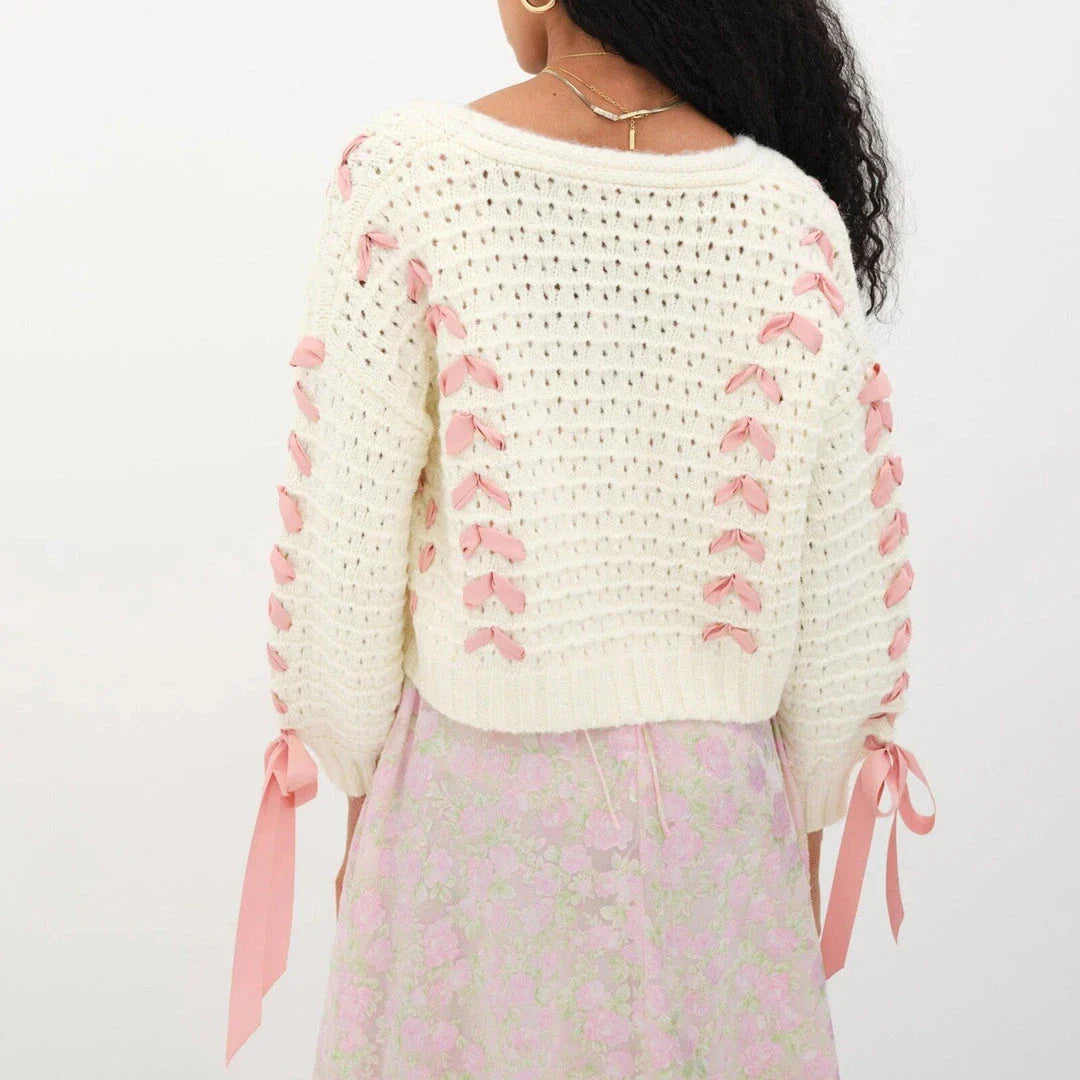 A versatile contrast V-neck tie cardigan in a soft, polyester fabric with a patchwork pattern and lace-up detail for a fashionable and comfortable layering piece.