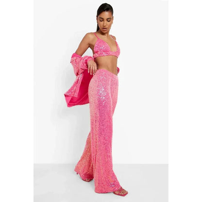 Elegant woman wearing a luxurious sequin top and pants set, perfect for a glamorous evening event