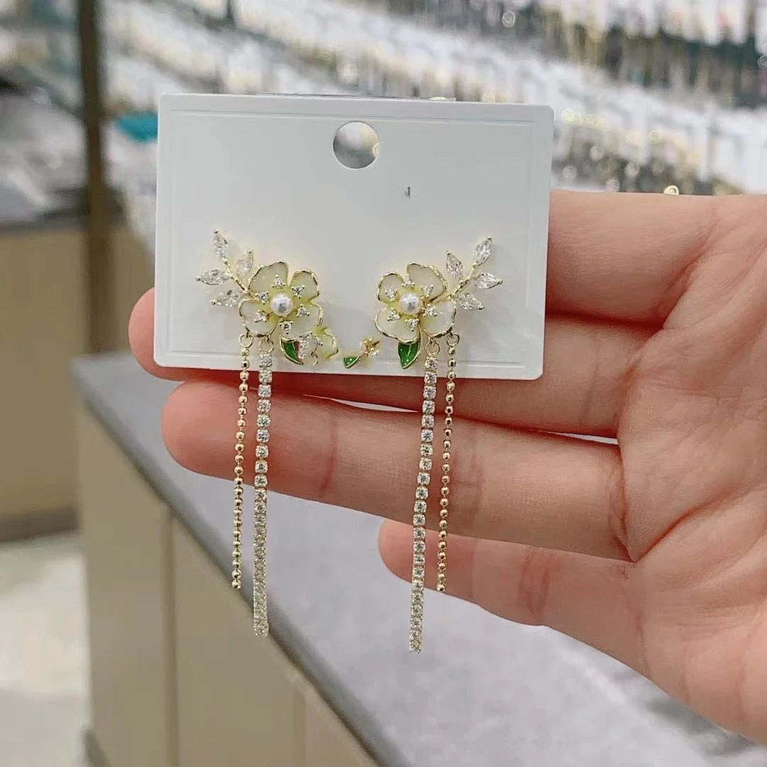 Elegant zircon flower long pearl tassel earrings in silver and gold tones, showcasing a captivating floral design and luxurious cascading tassels