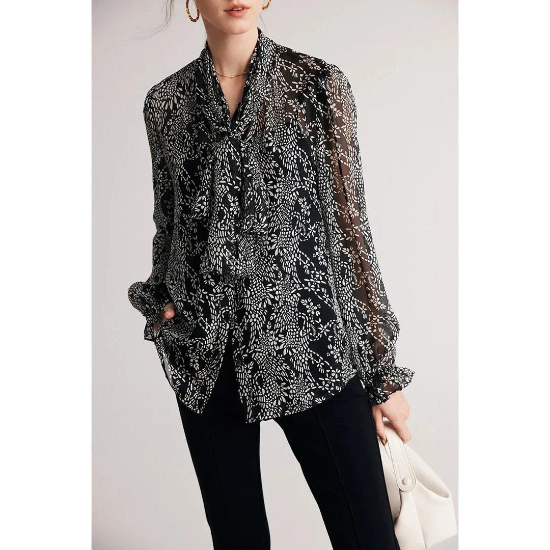 Elegant black silk blouse with unique bow collar, designed for a flattering fit and all-day comfort.
