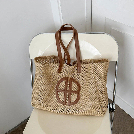 A handmade straw tote bag with a unique hollow-out knitting design, featuring a soft faux fur lining and a spacious interior for versatile use.