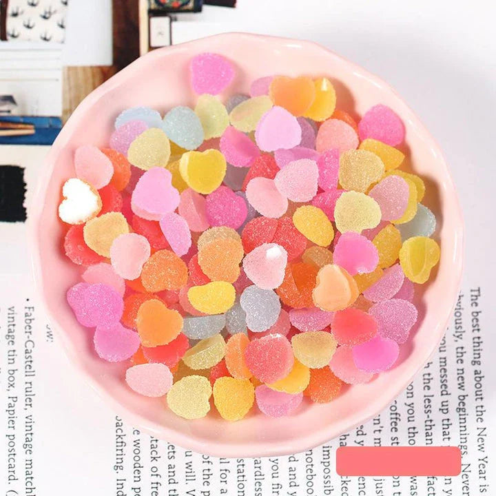 Heart and star-shaped nail charms with candy-inspired designs for creating unique and eye-catching nail art