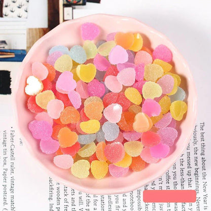 Heart and star-shaped nail charms with candy-inspired designs for creating unique and eye-catching nail art