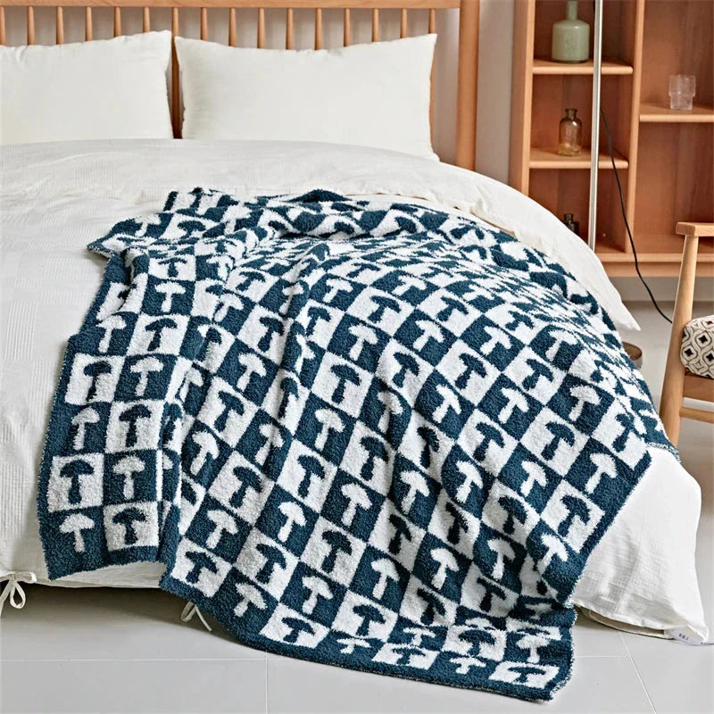 Cosy two-tone checkerboard plaid knitted throw blanket in various colours, including red, blue, grey, and purple
