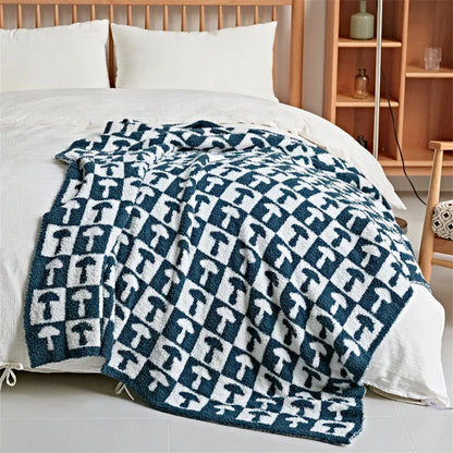 Cosy two-tone checkerboard plaid knitted throw blanket in various colours, including red, blue, grey, and purple