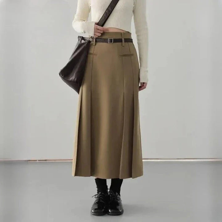 Elegant high-waisted pleated a-line skirt with a flattering silhouette and practical pockets, ideal for autumn and winter in the UK