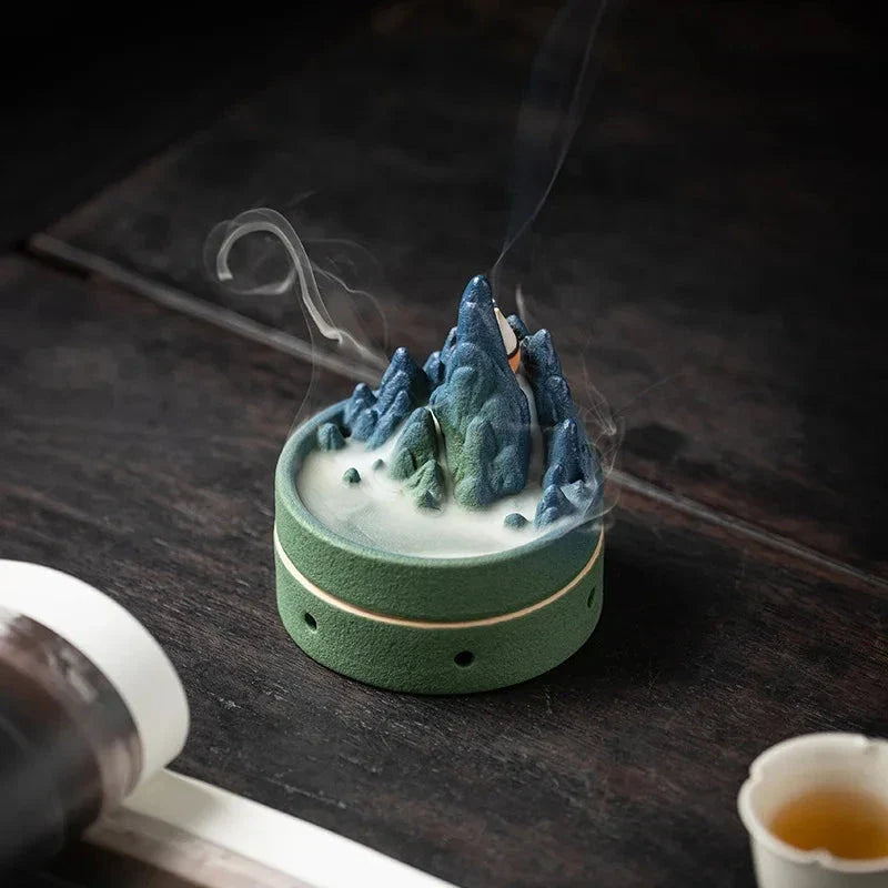 Elegant ceramic incense burner with a tranquil mountain and river design, creating a serene visual display
