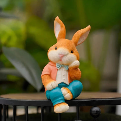 A detailed and lifelike resin statue of a thoughtfully sitting rabbit, adding a whimsical touch to any home or garden decor.