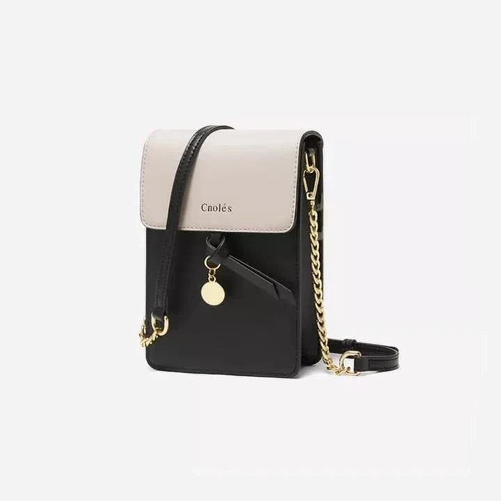 Stylish black leather crossbody phone bag with tassel accent, offering secure storage and versatile design for everyday use.