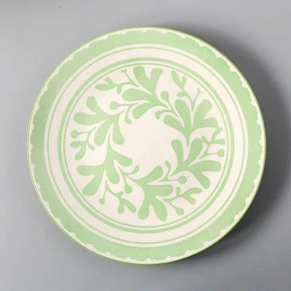 Elegant ceramic plates with vibrant, whimsical prints in a variety of enchanting designs