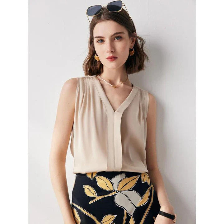 Elegant sleeveless silk blouse in a vibrant blue colour, designed for a sophisticated summer style