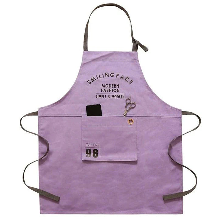 A stylish and practical Nordic-inspired canvas barista apron with a spacious front pocket and adjustable neck strap for a comfortable fit.