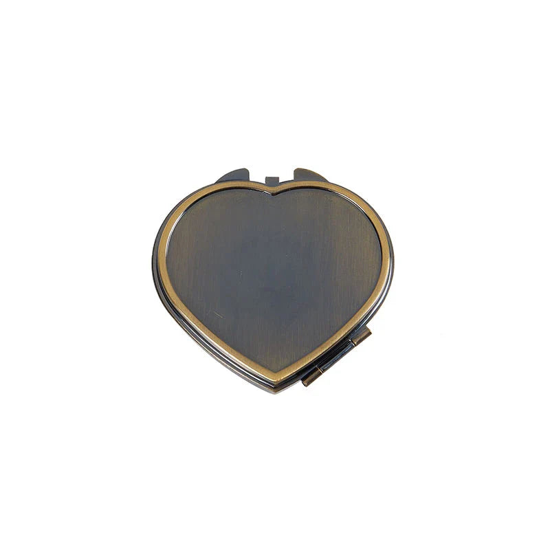 Elegant heart-shaped metal pill box with mirror for organized storage and convenient touch-ups