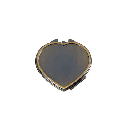 Elegant heart-shaped metal pill box with mirror for organized storage and convenient touch-ups
