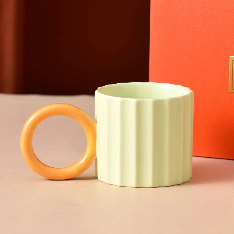 Japanese-style ceramic coffee mug with a unique ripple handle design, perfect for hot and cold beverages