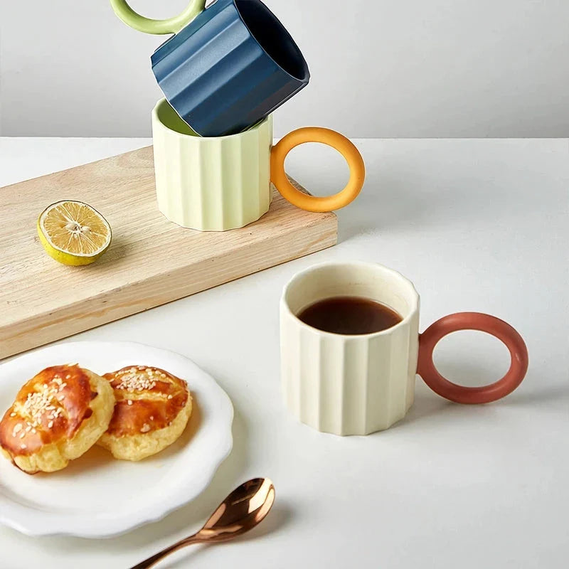 Japanese-style ceramic coffee mug with a unique ripple handle design, perfect for hot and cold beverages