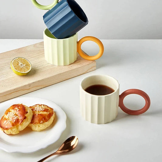 Japanese-style ceramic coffee mug with a unique ripple handle design, perfect for hot and cold beverages
