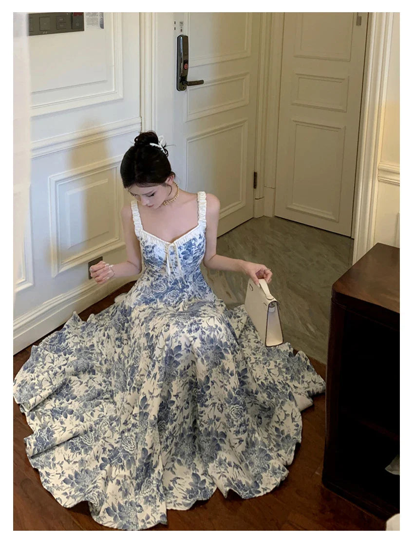 Elegant floral print dress with adjustable straps, A-line silhouette, and high-waisted design for a timeless British fashion look.