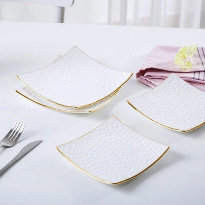 Elegant embossed ceramic cake plate in white, perfect for serving desserts and platters.
