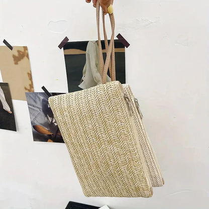 A natural straw-woven clutch with a zipper closure, perfect for summer outings in the UK.