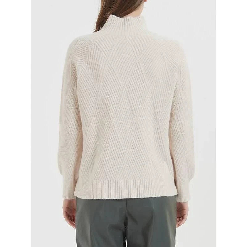 A cosy and stylish knitted turtleneck sweater in a classic beige colour, perfect for layering during the autumn and winter seasons.