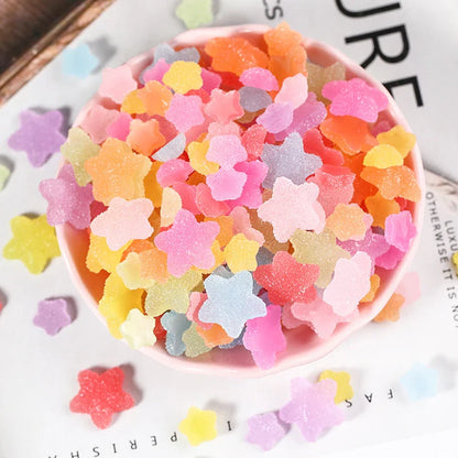 Heart and star-shaped nail charms with candy-inspired designs for creating unique and eye-catching nail art
