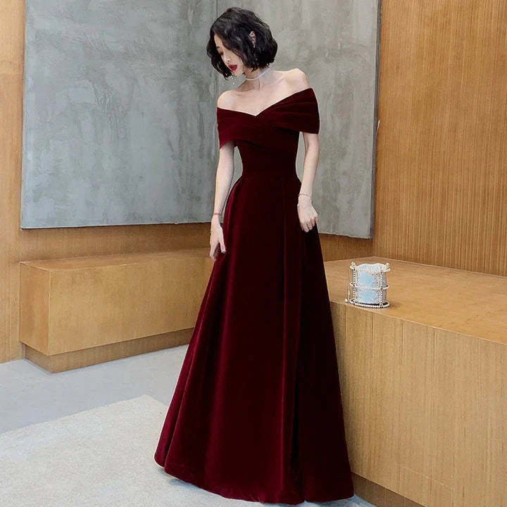 Off-shoulder wine red bridal dress with long, flowing skirt and tight waist for a sophisticated, elegant look