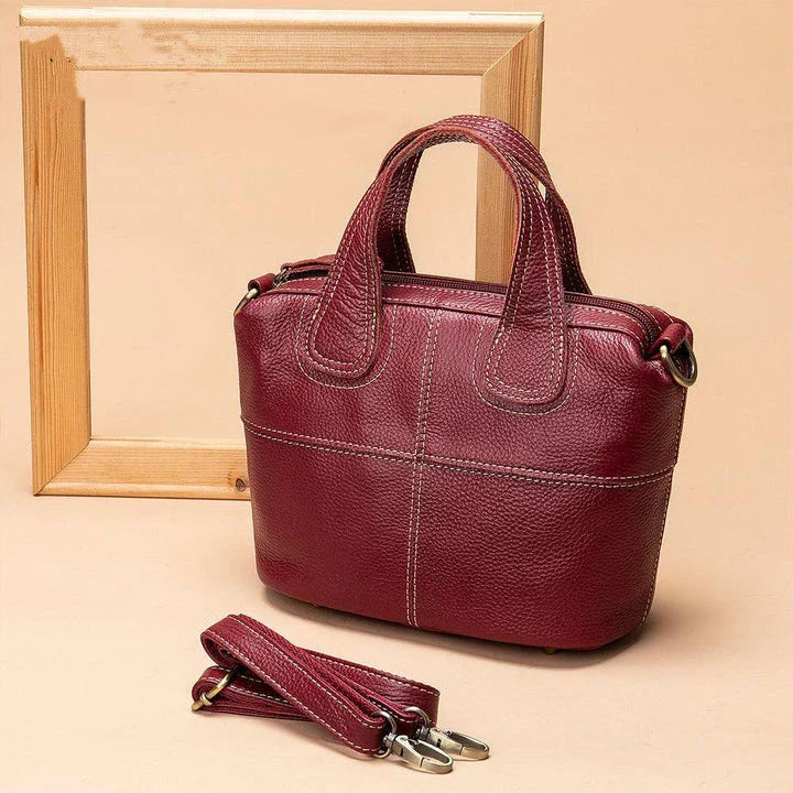 Premium leather shoulder bag for women in red, blue, and black colours with spacious interior and comfortable strap