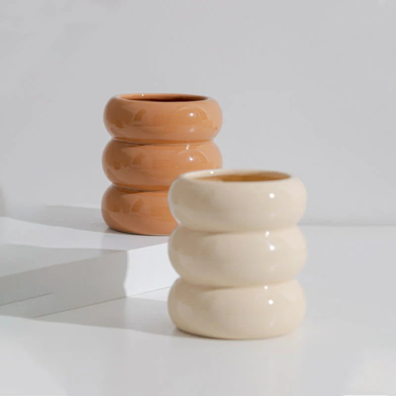 A white ceramic candlestick holder with a minimalist Nordic design, perfect for creating a cosy and sophisticated ambience in any room.