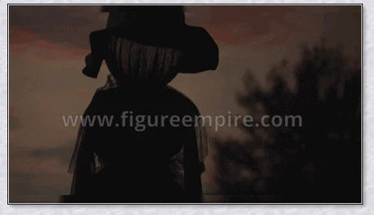 Three tall, black-robed witch figures with faceless glowing heads, standing together and holding hands, creating a spooky outdoor Halloween display