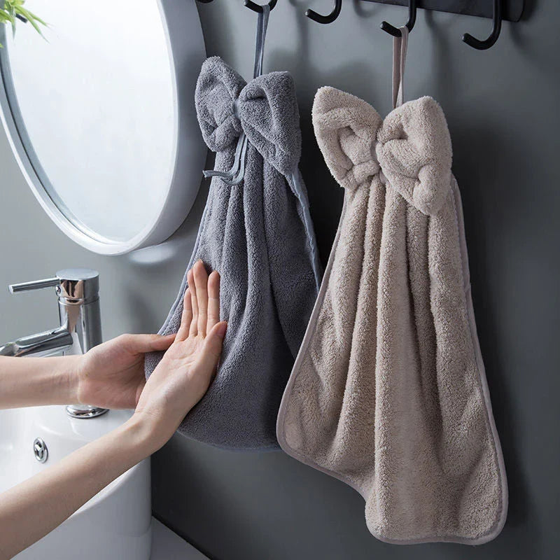 Elegant coral fleece hand towels with a unique bow design, perfect for kitchen and bathroom use