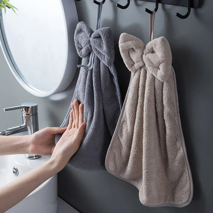 Elegant coral fleece hand towels with a unique bow design, perfect for kitchen and bathroom use