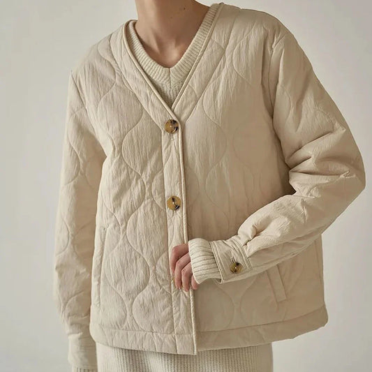 Women's black quilted jacket with button details, perfect for casual winter wear