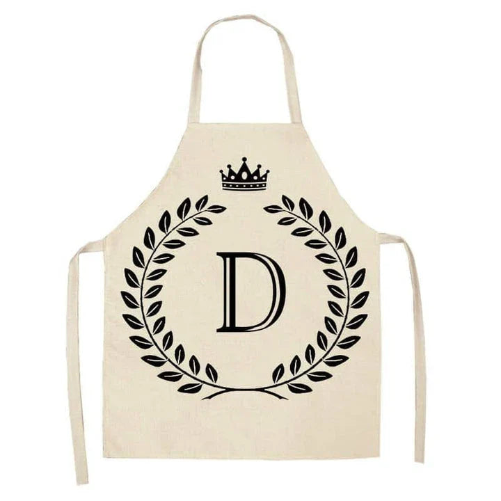 A high-quality kitchen apron featuring a charming crown and letter print design in a premium cotton and linen blend fabric.