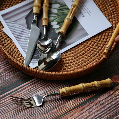 Mirror finish stainless steel cutlery set with bamboo handles, designed for elegant dining experiences