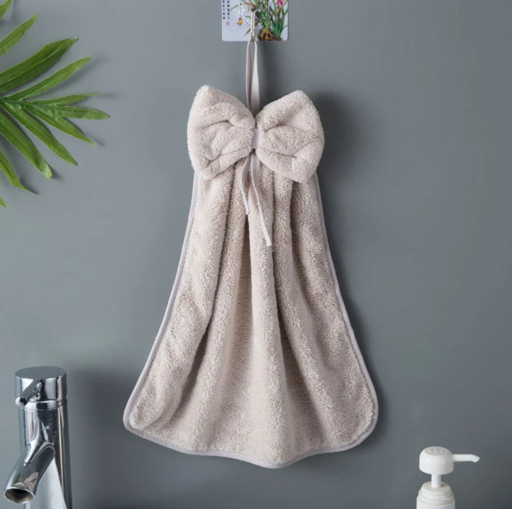 Elegant coral fleece hand towels with a unique bow design, perfect for kitchen and bathroom use
