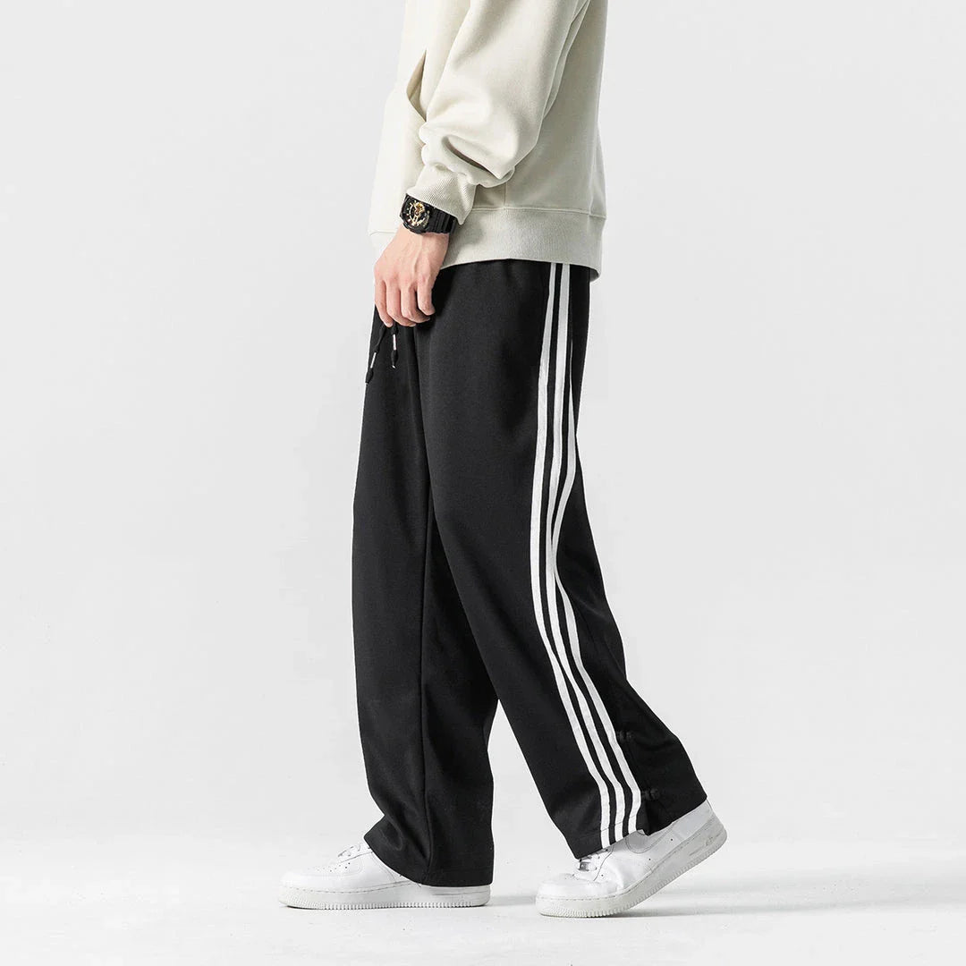 Stylish striped sports trousers in a relaxed, mid-waist design for versatile leisure and athletic wear