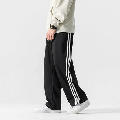Stylish striped sports trousers in a relaxed, mid-waist design for versatile leisure and athletic wear