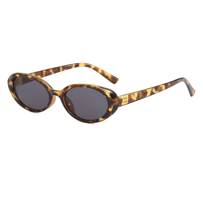 Oval-shaped women's sunglasses in a white and grey colour, offering UV protection and a stylish, retro-inspired design.