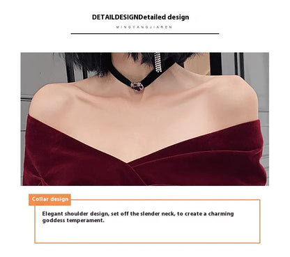 Off-shoulder wine red bridal dress with long, flowing skirt and tight waist for a sophisticated, elegant look