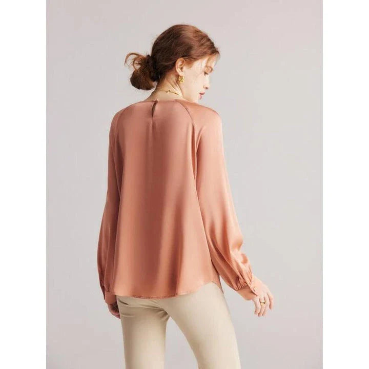 Elegant silk-blend blouse with raglan sleeves, featuring a timeless design and unique hollow-out details