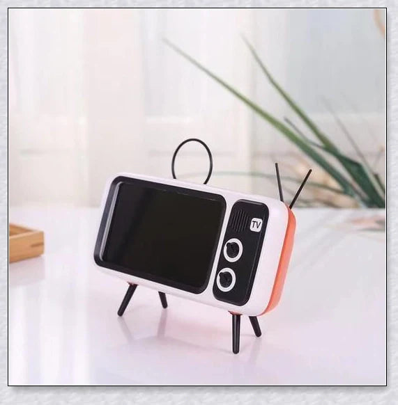 Retro TV-inspired phone stand with built-in Bluetooth speaker for hands-free entertainment and music playback