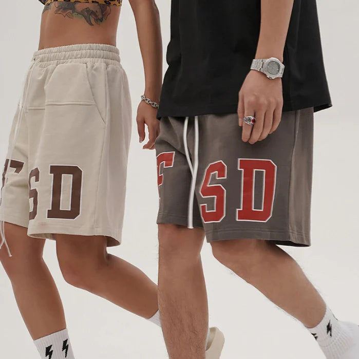 Premium loose-fit sports shorts with eye-catching printed patterns in black, khaki, and dark grey colours
