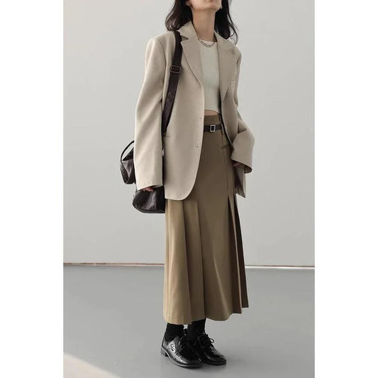 Elegant high-waisted pleated a-line skirt with a flattering silhouette and practical pockets, ideal for autumn and winter in the UK