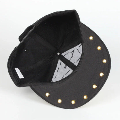 A black baseball cap with a striking skull and leopard print design, featuring adjustable snapback closure for a customized fit.
